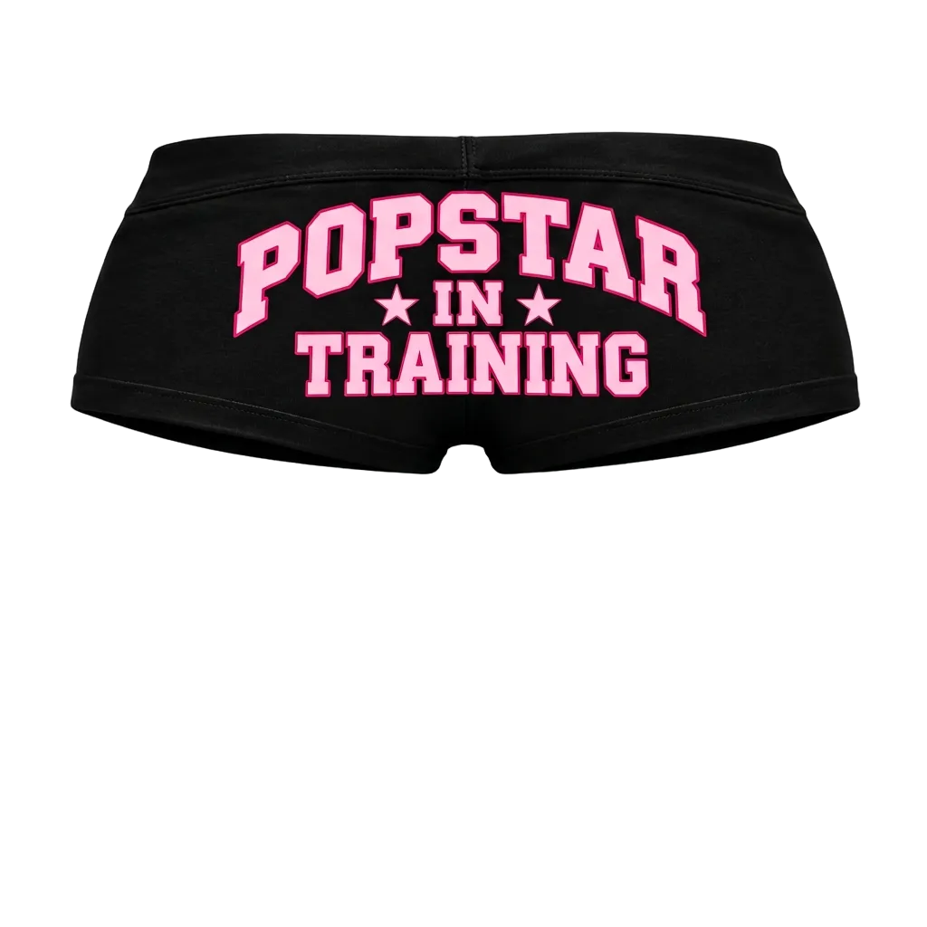 Black shorts with pink lettering, back view