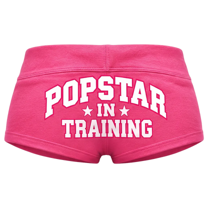 Pink shorts with white lettering, back view